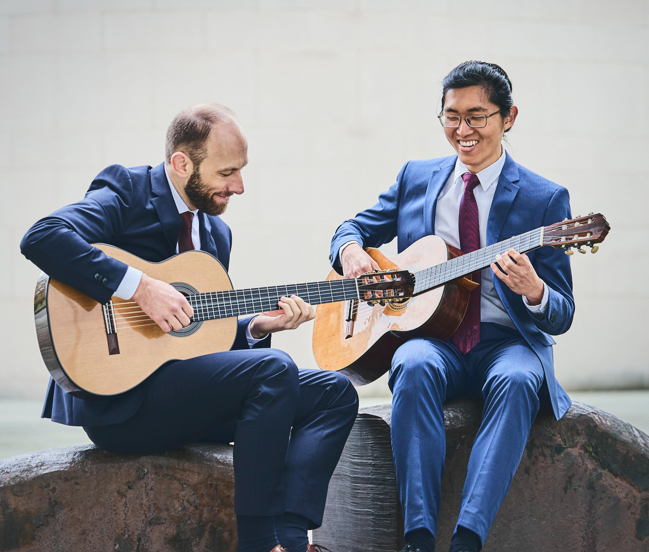 Two person playing on the classical guitar